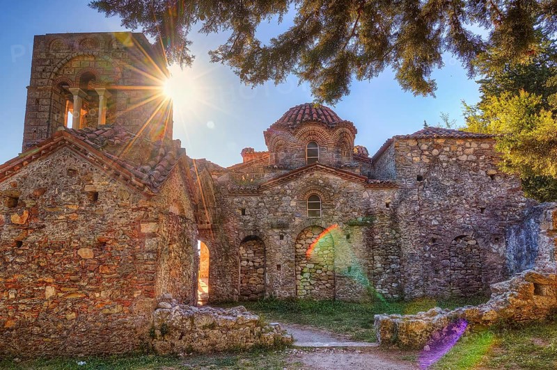 Abandoned stone church in sunlight, surrounded by trees and medieval atmosphere, UNESCO World Heritage Site, Agia Sophia Church, Mistra, Mystra, Byzantine City, Peloponnese, Greece