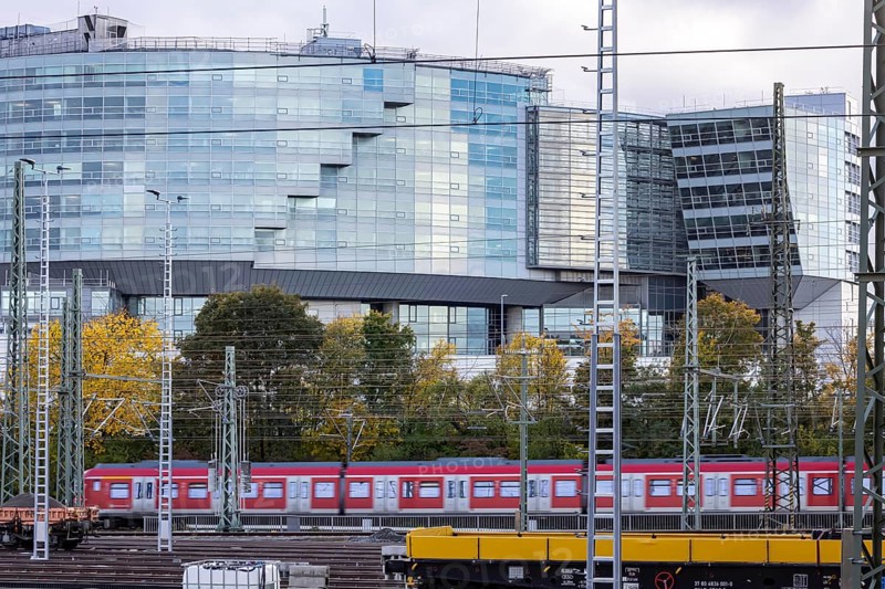 Modern architecture of the Mercedes-Benz Van Technology Center (VTC), in front of it an S-Bahn and rail tracks. Stuttgart, Baden-Württemberg, Germany