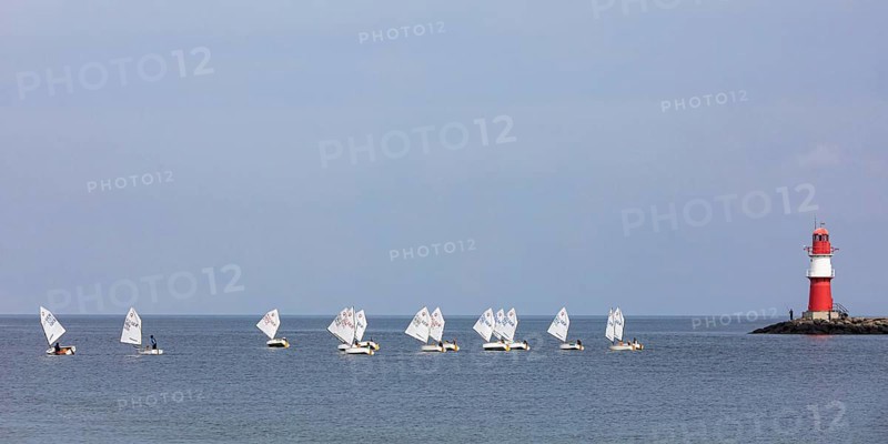 Sailing course with Optimist class sailboats, a sailing dinghy and the pier fire in Warnemünde, Baltic Sea, Mecklenburg-Western Pomerania, Germany