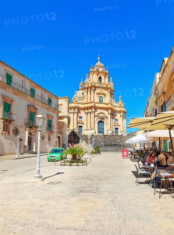 Tourists sitting in local restaurants in the main square, Ragusa Ibla, Ragusa province, Sicily, Italy