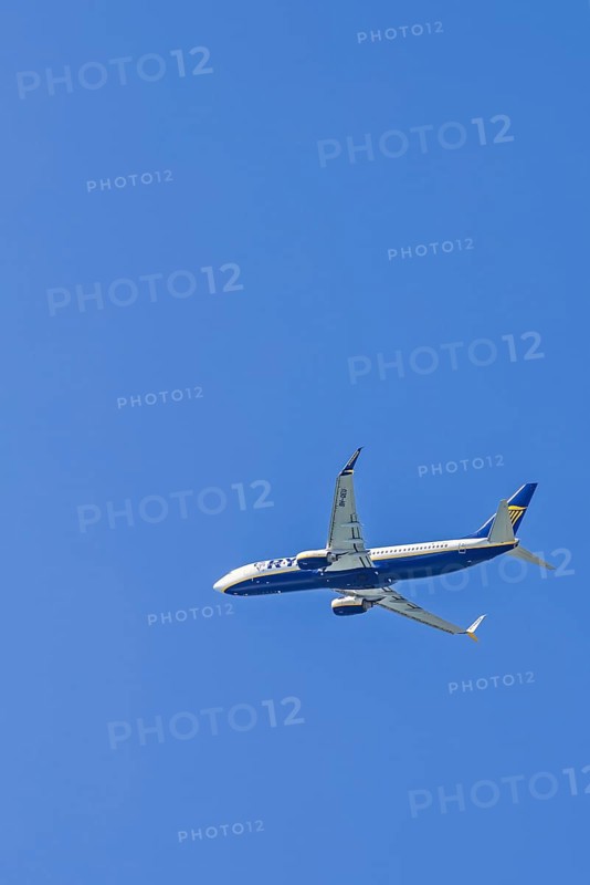 Ryanair passenger plane flying on a clear blue sky, Mallorca, Spain
