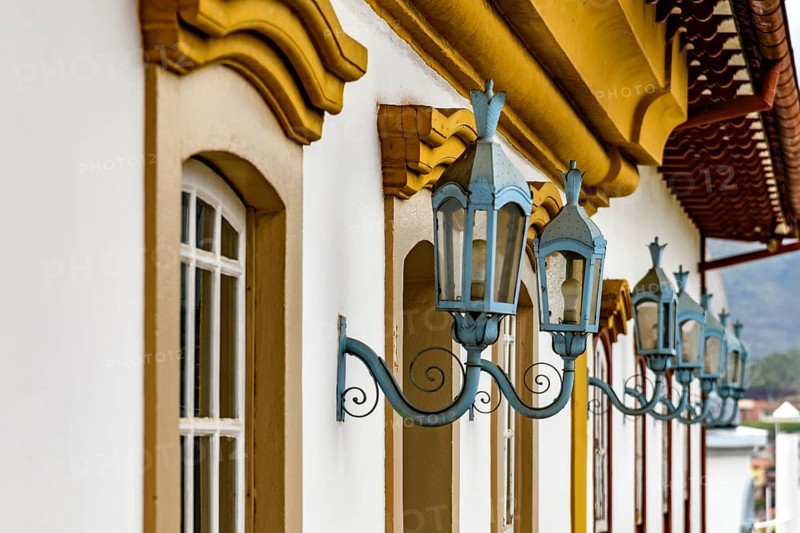 Antique metal lanterns decorating the facade of a historic colonial-style house in the city of Ouro Preto, Ouro Preto, Minas Gerais, Brazil