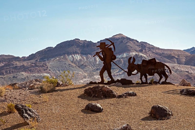 Beatty, Nevada - Art is the attraction in Rhyolite, a town that boomed briefly after gold was discovered in 1904. A gold prospector and his burro remind tourists of the town's history