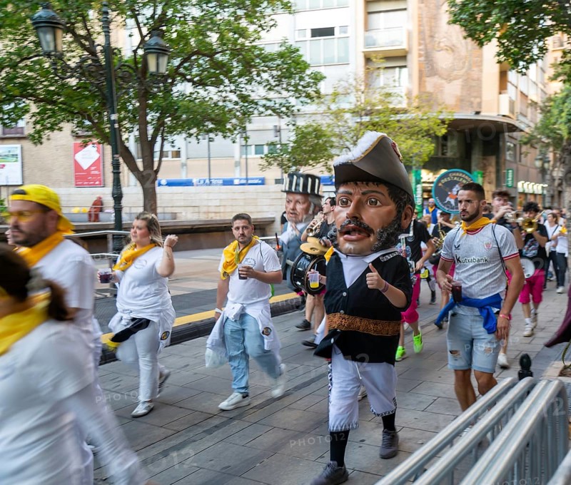 Evening procession through city streets by youth group organisation, Pilar 2025 festival event, Zaragoza, Aragon, Spain
