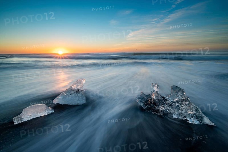 Beach with waves, ice formations, rising sun, Diamont Beach, Jökulsarlon, Iceland