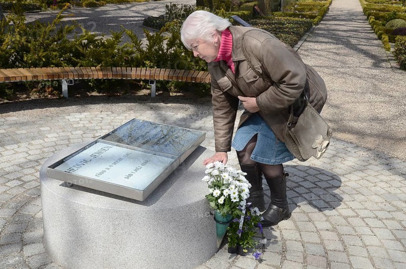 A woman looks at The grave of the love couple Danish circus artist Elvira Madigan Hedvig Jensen and Swedish officer Lieutenant Sixten Sparre at Landets Cemetery, Tåsinge Island, Funen, Denmark, Scandinavia