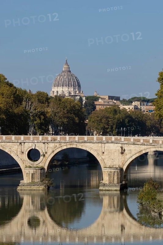 Bridge over the river Tiber with the dome of St. Peter's Basilica in the Vatican city in the background, Rome, Italy