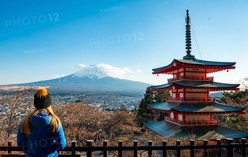 Tourist enjoying the view, five-story pagoda of a Shinto shrine, Chureito Pagoda, with views of Fujiyoshida City and Mount Fuji volcano, Arakura Fuji Sengen Shrine, Arakurayama Sengen Park, Yamanashi Prefecture, Japan