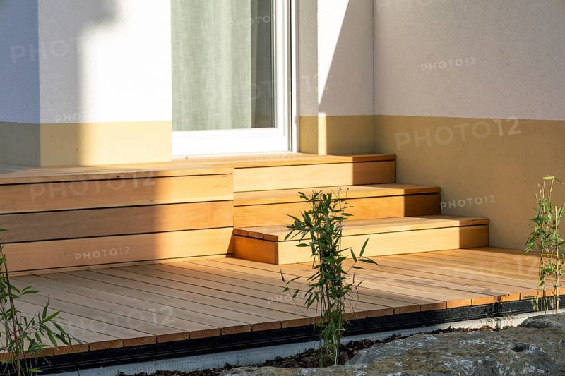 Beautiful wooden terrace on a newly landscaped garden
