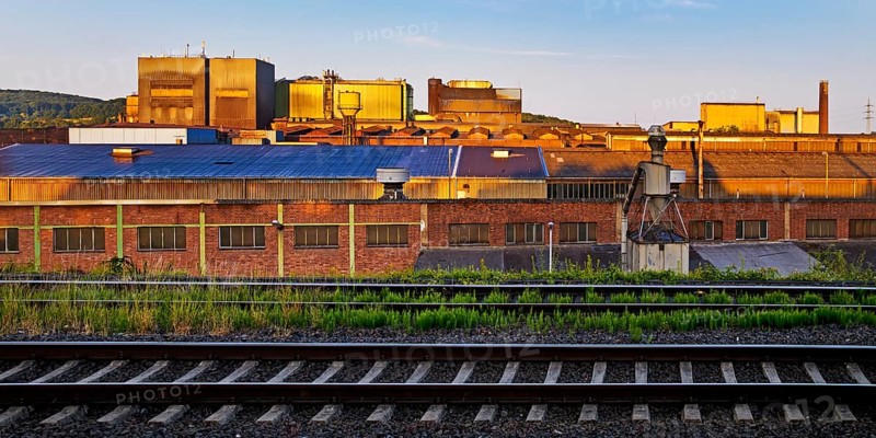 Deutsche Edelstahlwerke with train tracks at sunrise, central railway station, Witten, Ruhr region, North Rhine-Westphalia, Germany