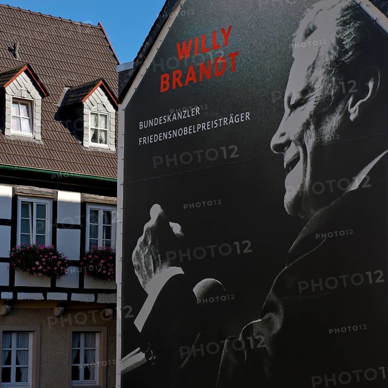 Huge poster with Willy Brandt portrait on a fire wall of the Willy Brandt Forum next to a half-timbered house, Altstadt, Unkel, Rhineland-Palatinate, Rhineland, Germany