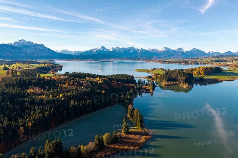 Autumn mountain landscape with a quiet lake and forests under blue sky, Illasbergsee, Forggensee, near Roßhaupten, Ostallgäu, Allgäu, Swabia, Bavaria, Germany
