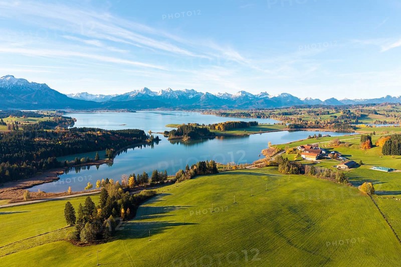 Picturesque landscape with a lake and mountains surrounded by green fields, Illasbergsee, Forggensee, near Roßhaupten, Ostallgäu, Allgäu, Swabia, Bavaria, Germany