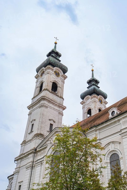 Two tall baroque church towers with crosses in the background of a cloudy sky, ZFP Zwiefalten, Reutlingen district, Germany