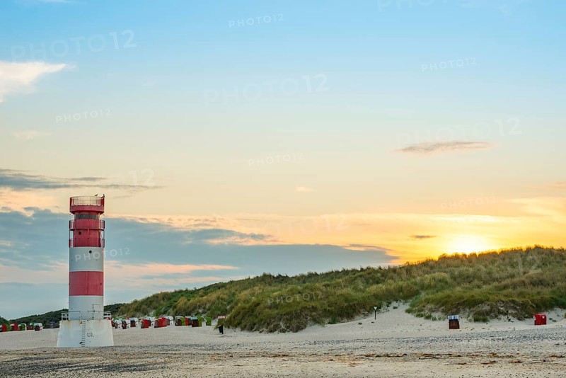 Red, white lighthouse Heligoland dune (Oberfeuer), striped, south beach, beach chairs, dunes, common beach oats (Ammophila arenaria (L.) Link, syn.: Calamagrostis arenaria (L.) Roth), also common beach oats, sand straw, deserted, no one, without people, warm, gentle sunlight at sunset, evening mood and relaxed atmosphere, atmospheric, colorful, quiet, vacation, summer, evening sun, dune island, Heligoland, Pinneberg district, Schleswig-Holstein, North Sea, Germany