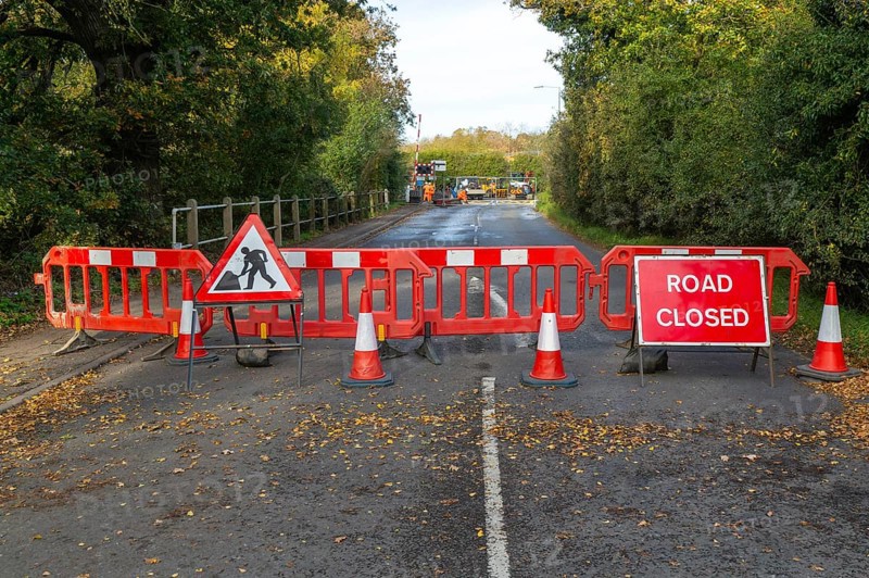 Road and rail level crossing closed, Network Rail railway line upgrade maintenance, Melton, Suffolk, England, UK autumn 2025