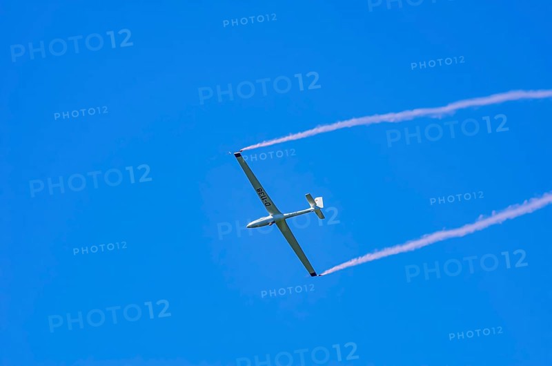 An SZD-59-1 ACRO glider, registration D-1138, during a demonstration as part of an air show at the Fliegerbergfest of the Rossfeld Luftsportverein in Metzingen-Glems, Baden-Württemberg, Germany, for editorial use only