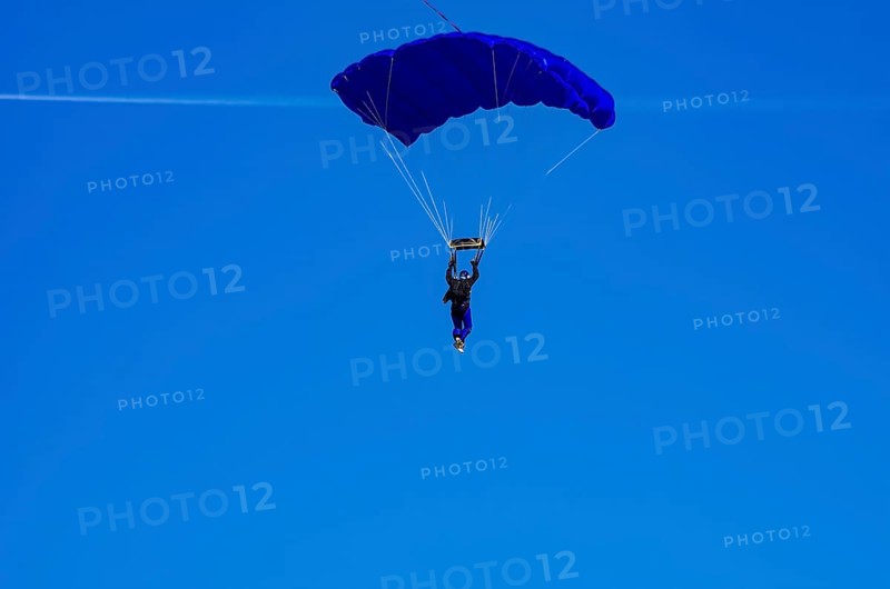 Skydivers during an aerial acrobatic performance as part of an air show at the Fliegerbergfest of the Rossfeld Luftsportverein in Metzingen-Glems, Baden-Württemberg, Germany, for editorial use only