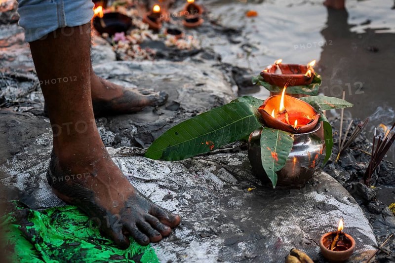 A Hindu devotee offer prayers to the Sun God on the bank of Brahmaputra river on the occasion of Chhath Puja, in Guwahati, India on 27 October 2025