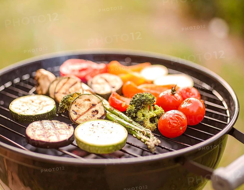 Cooking vegetables on grill outdoors, healthy lifestyle with healthy food, close up of grill with blurred background, soft golden light, picnic in the green park or garden, no people, AI generated