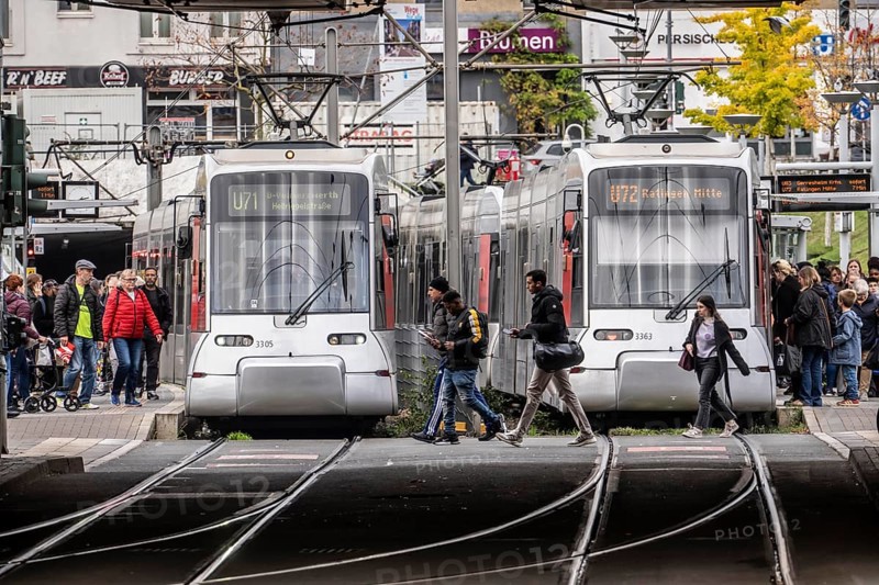 Pedestrians cross the tram tracks, at Düsseldorf-Bilk station, junction of S-Bahn, subway, tram, local bus transport, North Rhine-Westphalia
