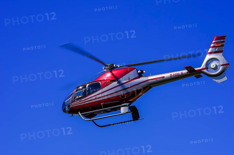 A Eurocopter EC 120B Colibri helicopter, D-HALX registration, during a flight demonstration as part of an air show on Rossfeld in Metzingen-Glems, Baden-Württemberg, Germany, for editorial use only