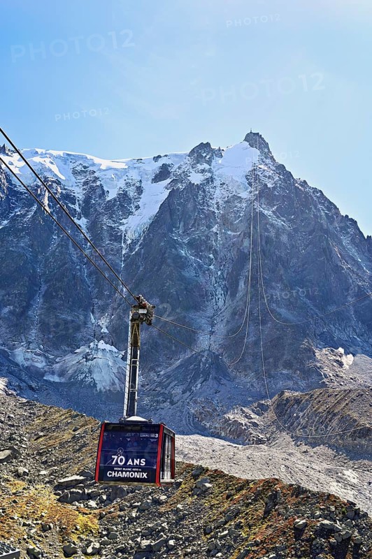 View of the arriving cable car from the Plan de l'Aiguille middle station, in the back the mountain station of the Aiguille du Midi, Chamonix-Mont-Blanc, Haute-Savoie, France