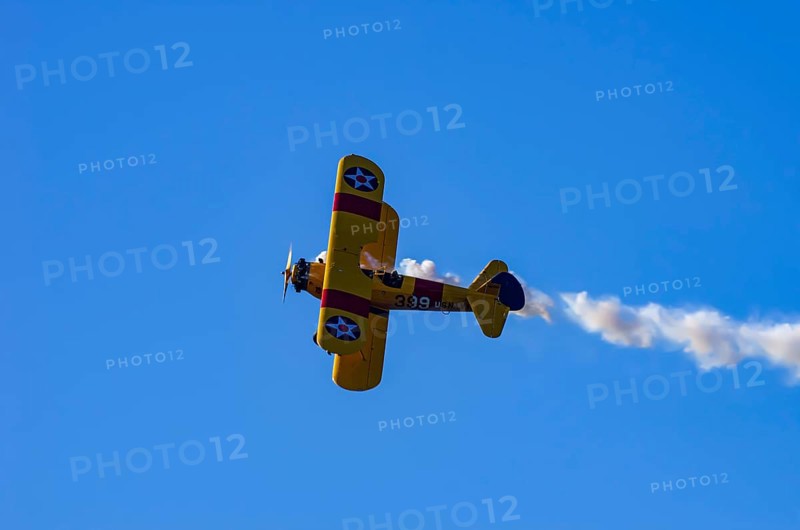 A Boeing PT-17 Stearman biplane, also Boeing Stearman Model 75, with the inscription 399 USNAVY N67193 during a flight demonstration as part of an air show on Rossfeld in Metzingen-Glems, Baden-Württemberg, Germany, for editorial use only