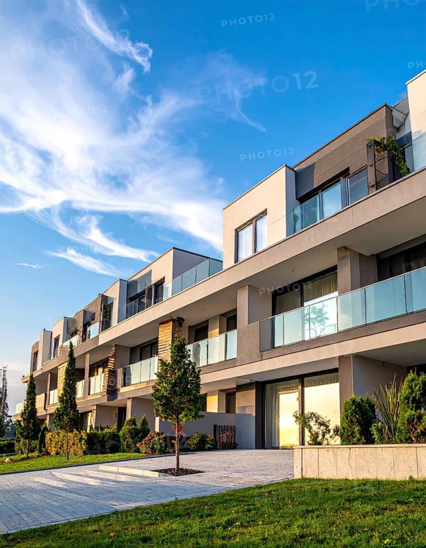 New modern block of flat, condo architecture, Residential apartment as a flat, luxury house complex, City real estate property, green garden plants in front, clear blue sky with golden evening light, AI generated