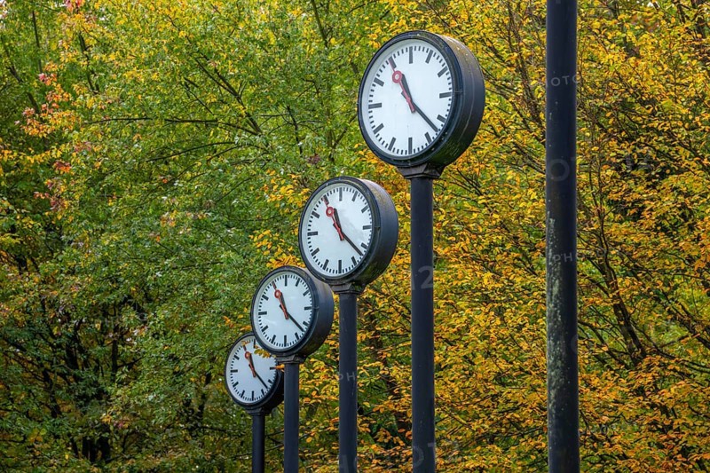 The art installation Zeitfeld in Volksgarten Park in Düsseldorf-Oberbilk, a total of 24 station clocks, on 6 meter high steel columns, have been running synchronously since 1987, artwork by Düsseldorf artist Klaus Rinke, symbol of time, time change, North Rhine-Westphalia, Germany