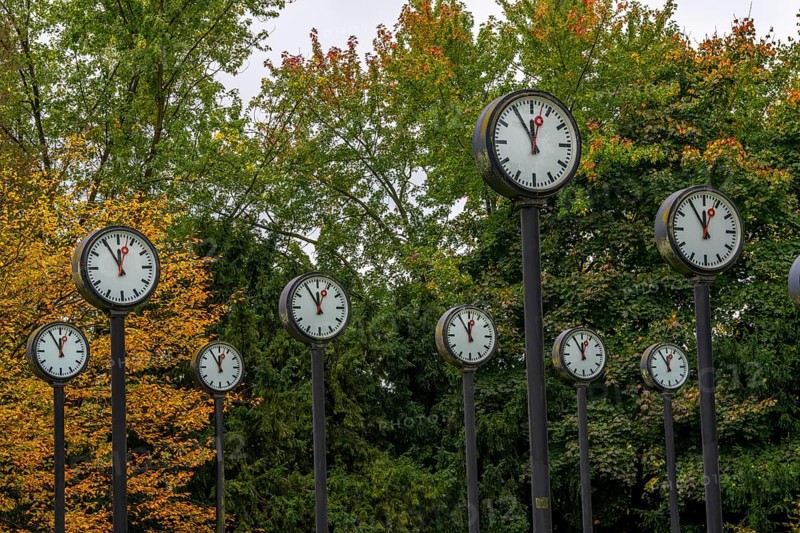 The art installation Zeitfeld in Volksgarten Park in Düsseldorf-Oberbilk, a total of 24 station clocks, on 6 meter high steel columns, have been running synchronously since 1987, dial shows five to twelve, artwork by Düsseldorf artist Klaus Rinke, symbol of time, time change, North Rhine-Westphalia, Germany