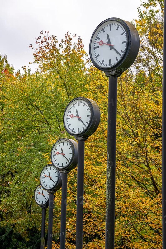 The art installation Zeitfeld in Volksgarten Park in Düsseldorf-Oberbilk, a total of 24 station clocks, on 6 meter high steel columns, have been running synchronously since 1987, artwork by Düsseldorf artist Klaus Rinke, symbol of time, time change, North Rhine-Westphalia, Germany