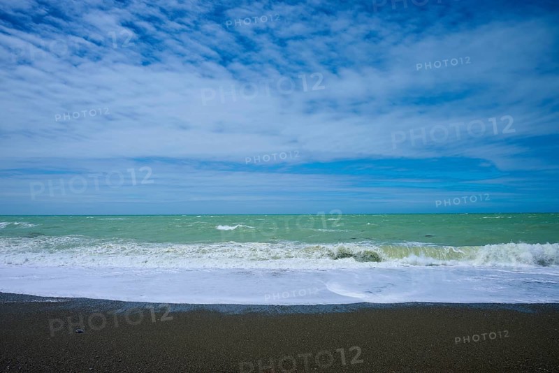 Wavy beach with calm sky in the background, Tuhawaiki Point Lighthouse or Jack's Point Lighthouse, Scarborough, Timaru, South Island, New Zealand