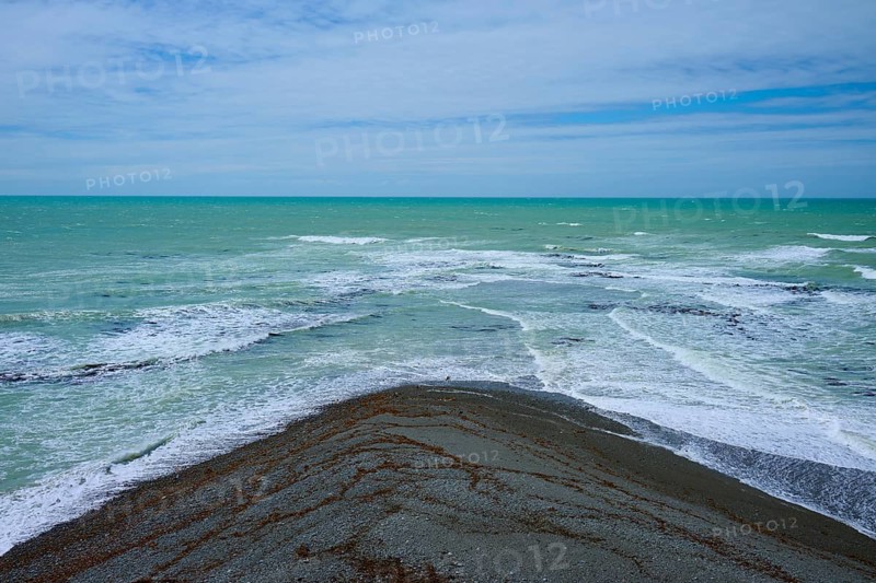 Sea with foaming waves and cloudy sky, Tuhawaiki Point Lighthouse or Jack's Point Lighthouse, Scarborough, Timaru, South Island, New Zealand