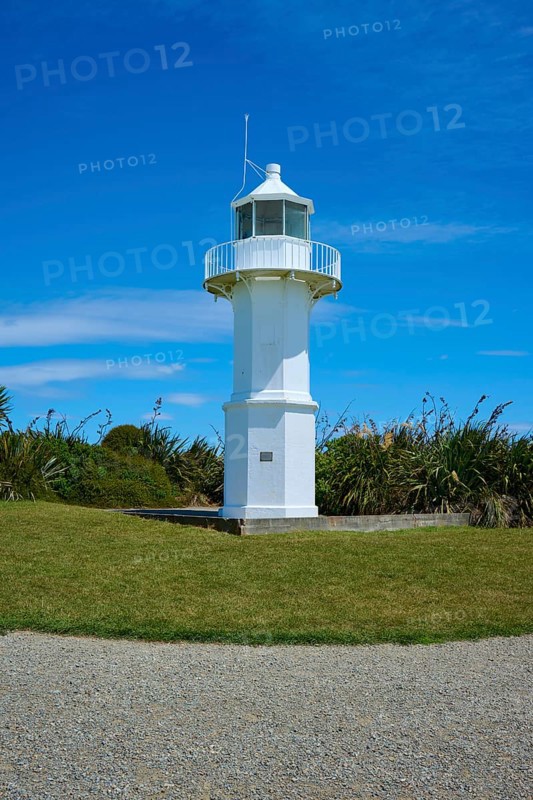 White lighthouse in a meadow next to the coast, Tuhawaiki Point Lighthouse or Jack's Point Lighthouse, Scarborough, Timaru, South Island, New Zealand