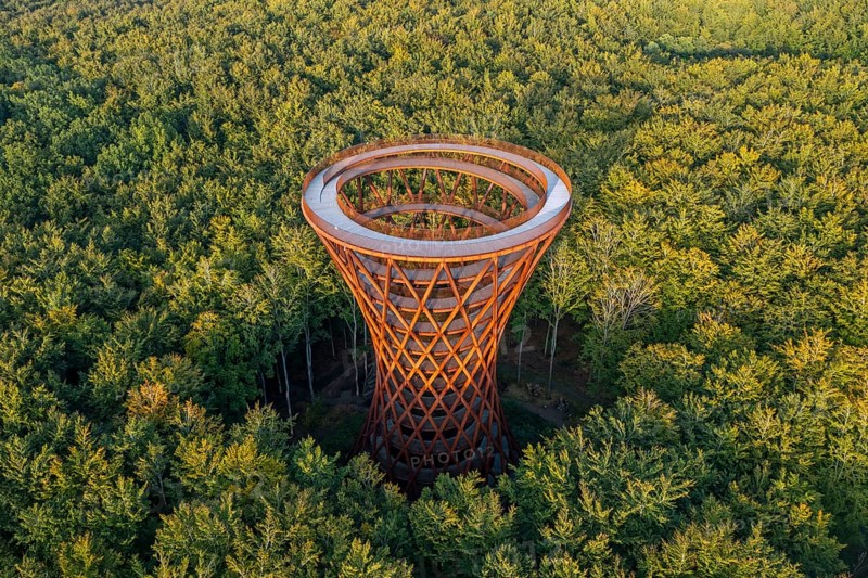 Aerial view over 45-meter-tall hyperboloid observation tower in forest near Gisselfeld monastery at Haslev on Zealand island in late summer, Denmark
