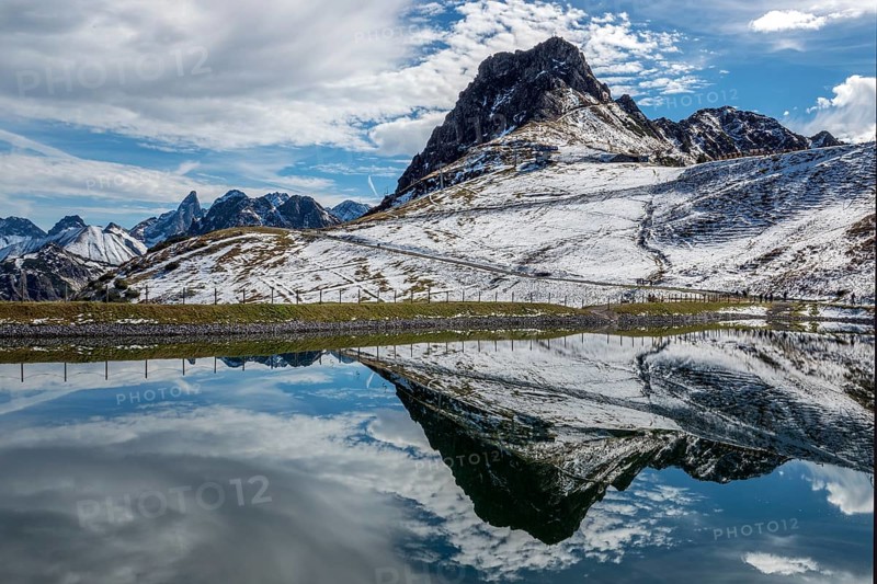 Kanzelwand is reflected in the reservoir, Kanzelwand snow-making pond, mountains of the Allgäu Alps behind, Vorarlberg, Austria