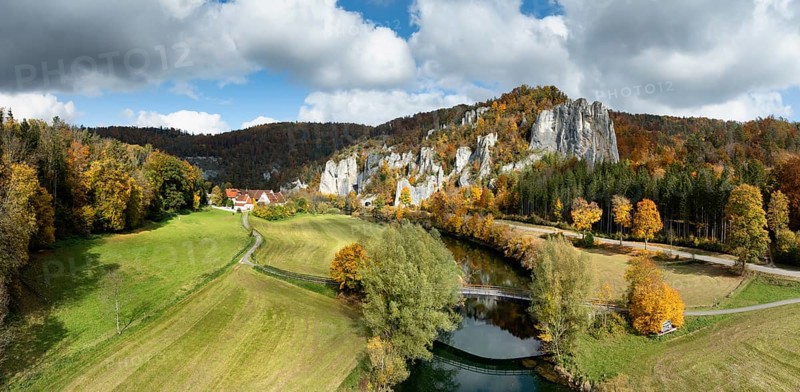 Aerial view, panorama of Käppeler estate with the St. George's Basilica near Thiergarten in the upper Danube Valley, surrounded by autumn vegetation, on the right the raven rocks, climbing rocks, Jura limestone rocks, Sigmaringen district, Baden-Württemberg, Germany