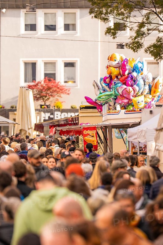 Busy shopping street in autumn, people strolling between modern buildings and colorful shops, Urschelherbst street festival, Nagold, Germany