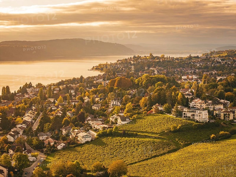 A view of an urban landscape with a lake surrounded by autumn tones, Überlingen, Lake Constance, Germany