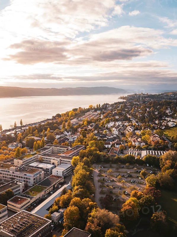 Aerial view of a lakeside town in autumn weather with beautiful clouds and buildings, Überlingen, Lake Constance, Germany
