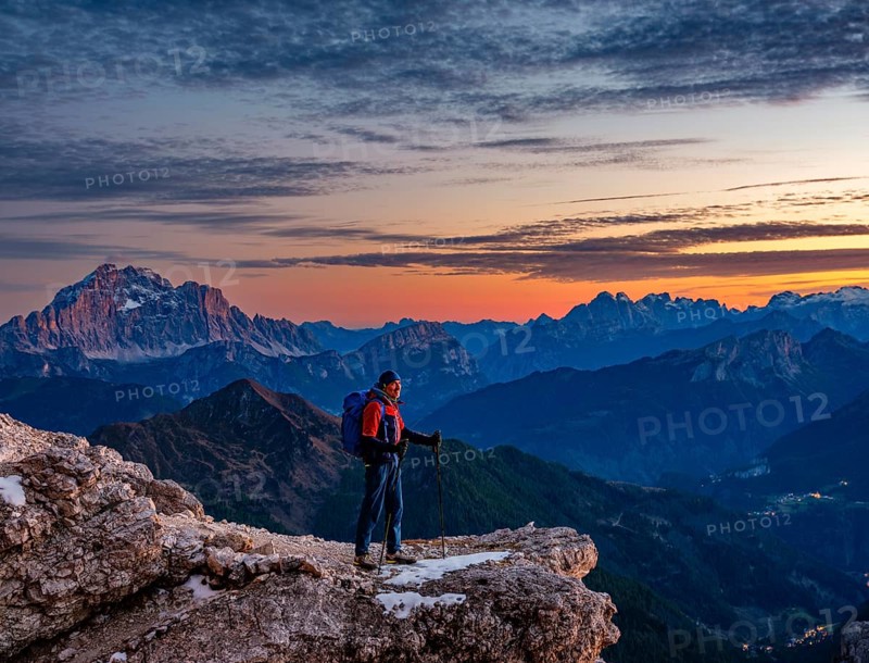 Mountaineers in front of rugged Dolomite peaks in the evening light, Dolomites, Alps, Belluno province, Veneto region, Italy