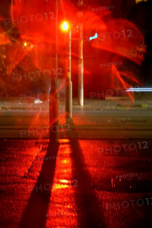 Traffic light, road traffic at night and poor visibility in a city, autumn, Germany