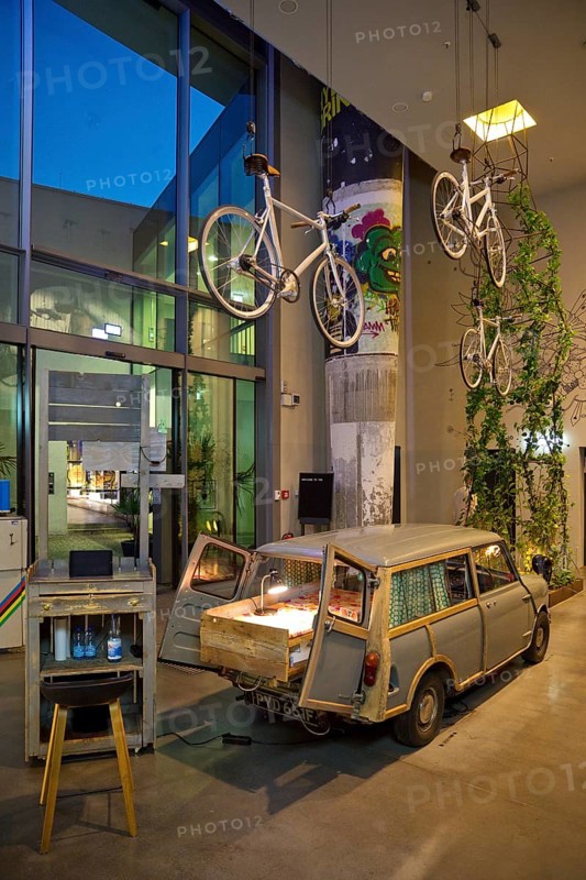 Entrance area to Monkey Bar with old Trabi in the evening, Charlottenburg, Berlin, Germany