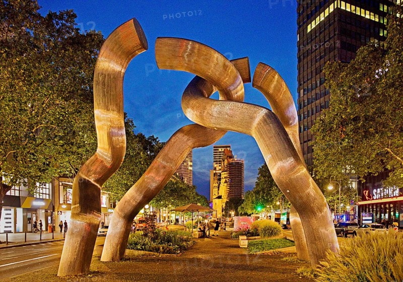 The sculpture entitled Berlin by Brigitte and Martin Matschinsky-Denninghoff with Kaiser Wilhelm Memorial Church in the evening, Charlottenburg, Berlin, Germany