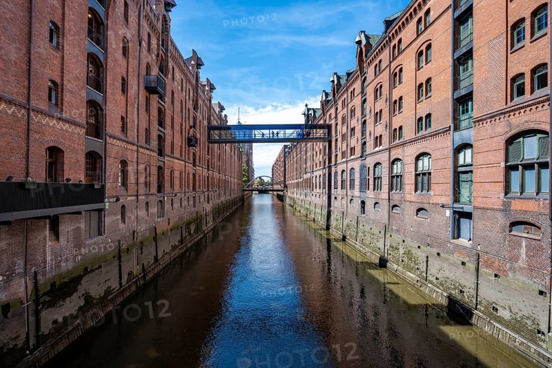 Canal between red brick buildings, warehouses in Hamburg's Speicherstadt, Hamburg, Germany
