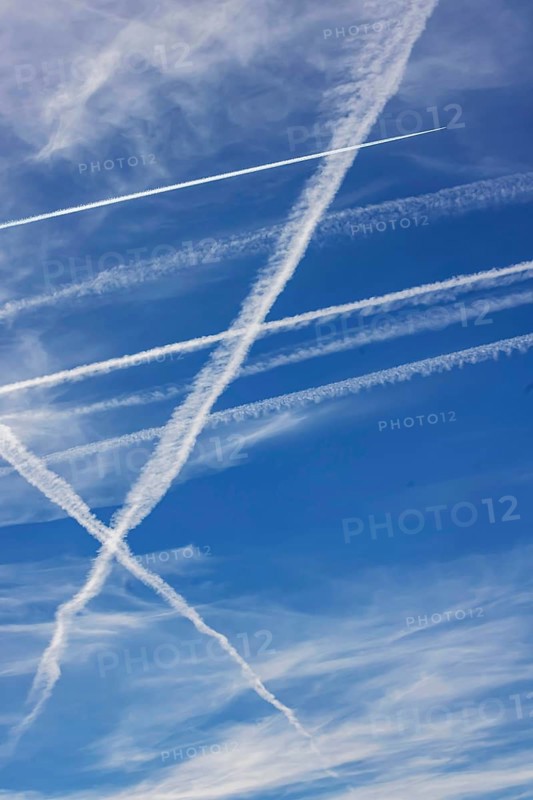 Contrails in the sky. These artificial clouds are created from the exhaust fumes of aeroplanes. But there are also conspiracy theory myths. Stuttgart, Baden-Württemberg, Germany