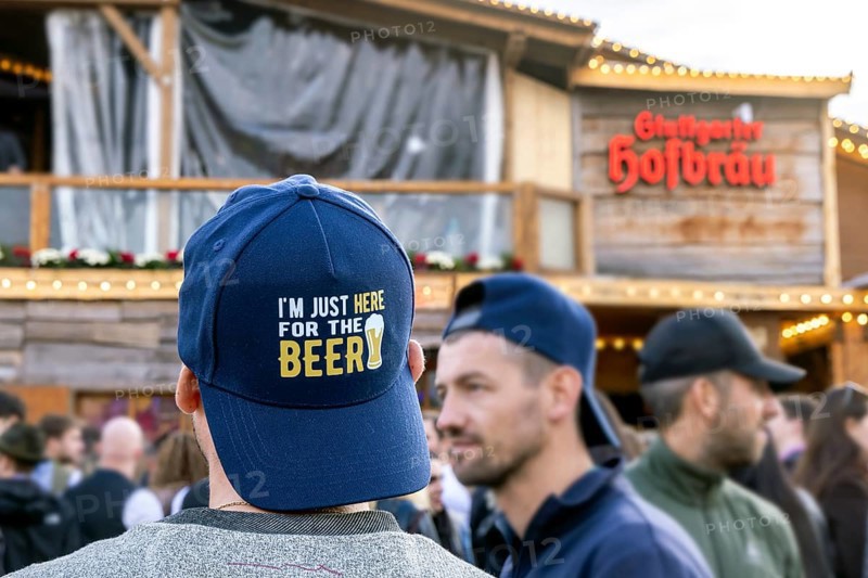I'm just here for the beer. Cap with a toast. Cannstatter Volksfest on the Wasen. Bad Cannstatt, Stuttgart, Baden-Württemberg, Germany