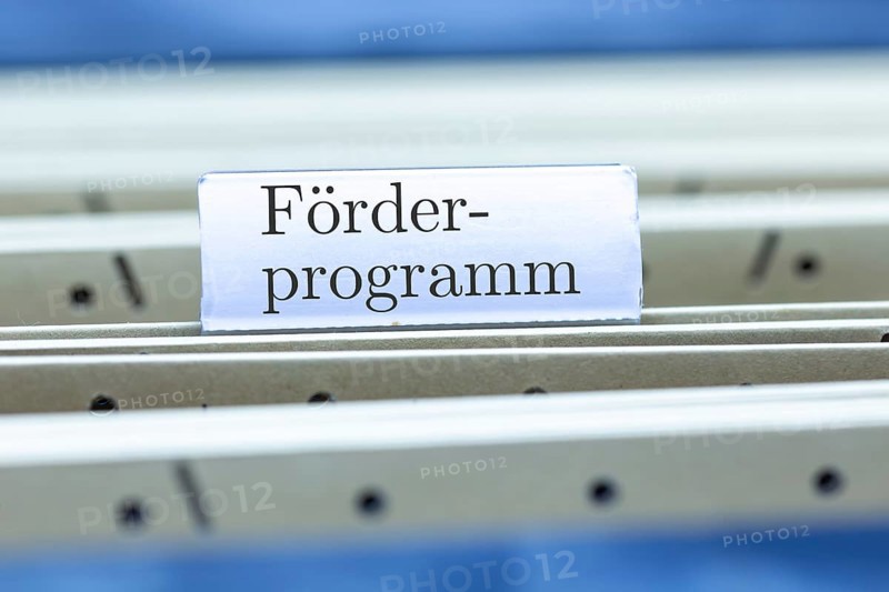 (Photomontage) Sign with the inscription FÖRDERPROGRAMM on a hanging folder index