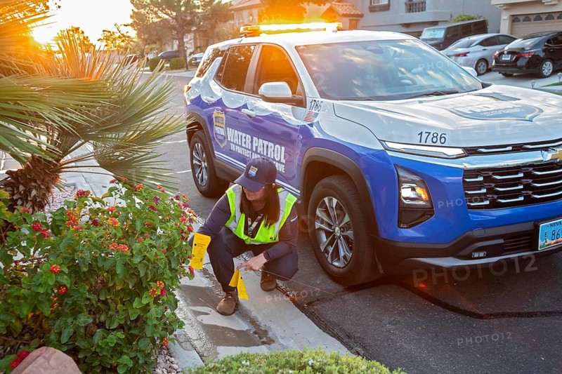 Las Vegas, Nevada - Devyn Choltko, a water waste investigator, patrols a residential neighborhood issuing tickets for illegal water use. The Las Vegas Valley Water District has cut usage of scarce Colorado River water by more than 30% over the last 20 years despite a growing population
